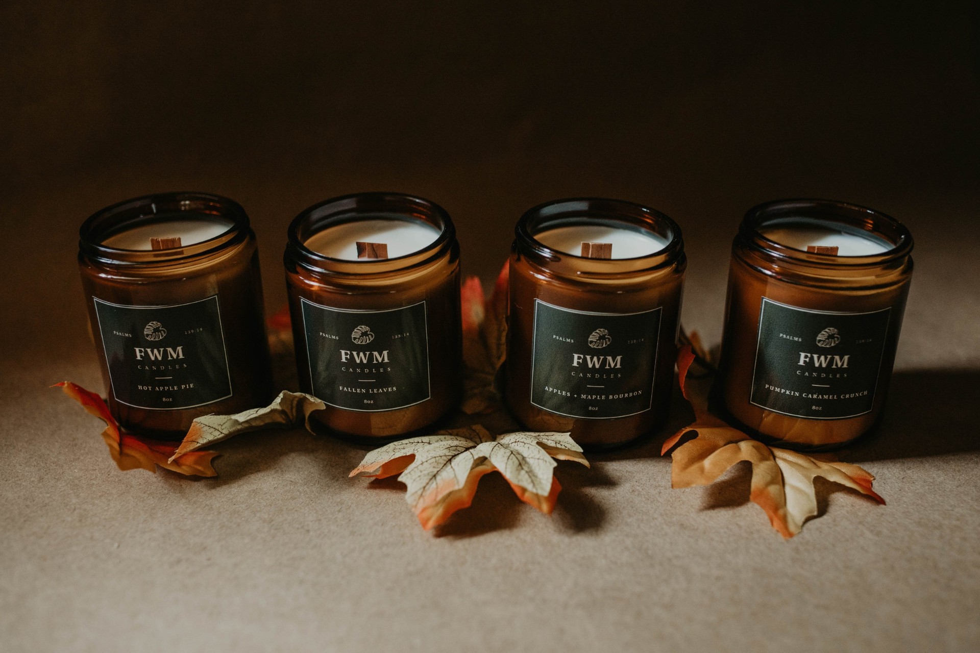 FWM Candles amber jar lineup with fall leaves